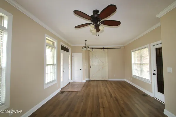 wooden floor in an empty room with a window