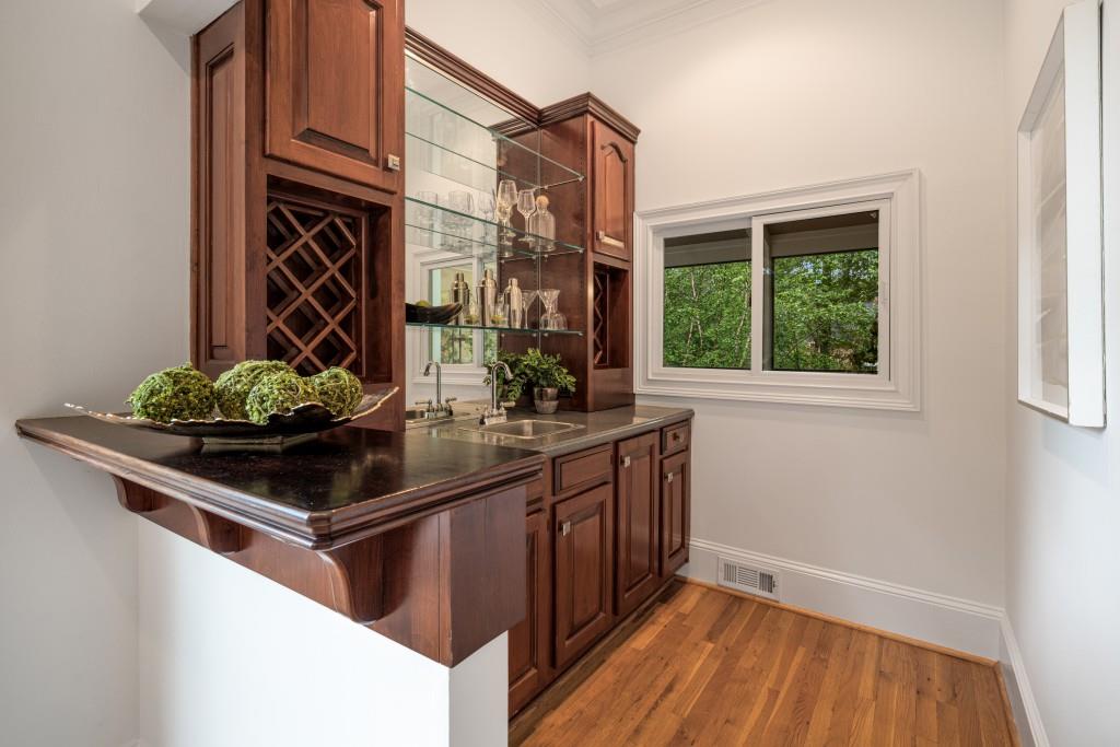 8345 Jett Ferry Road Sandy Springs, GA 30350 - Photo 13 of 61 a kitchen with stainless steel appliances granite countertop a sink and a wooden floor