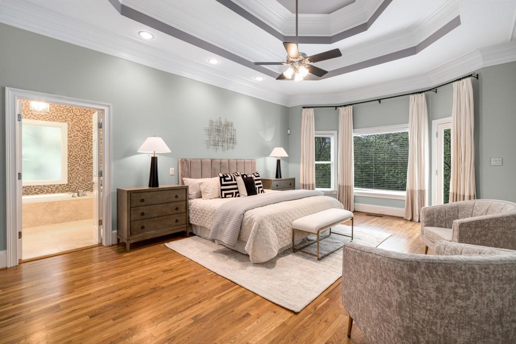 8345 Jett Ferry Road Sandy Springs, GA 30350 - Photo 14 of 61 a spacious bedroom with a large bed and a window