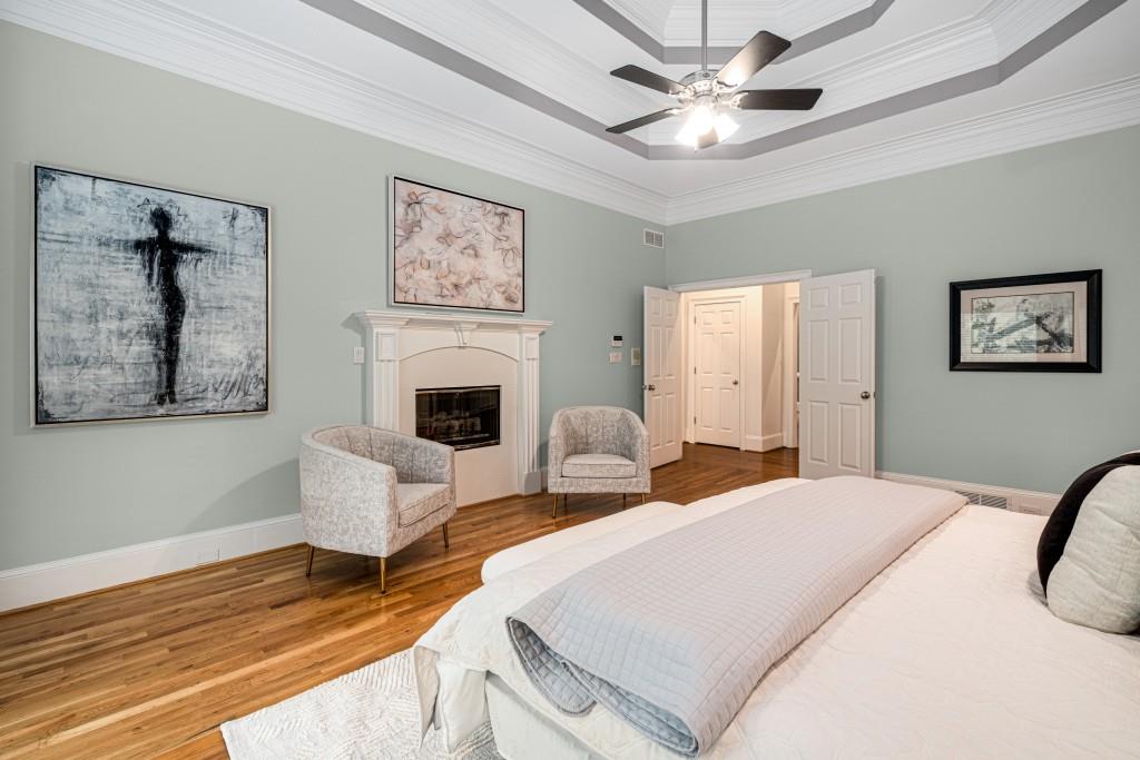 8345 Jett Ferry Road Sandy Springs, GA 30350 - Photo 15 of 61 a bedroom with a large bed and a chandelier