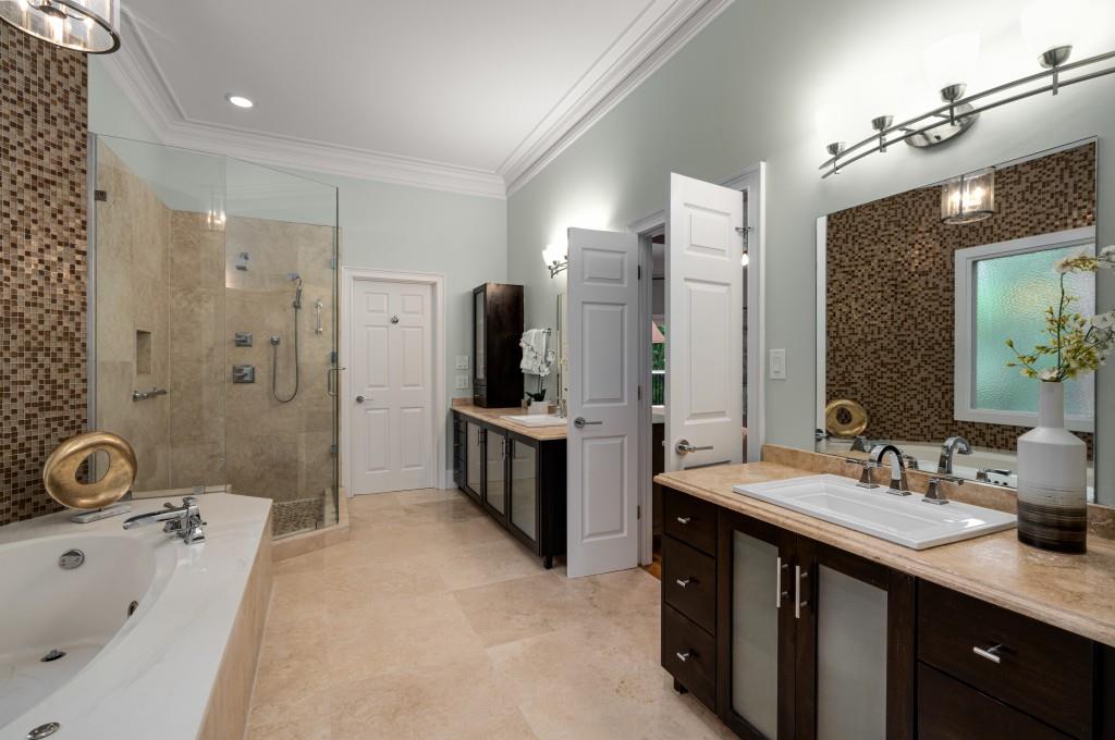 8345 Jett Ferry Road Sandy Springs, GA 30350 - Photo 16 of 61 a spacious bathroom with a tub sink and mirror
