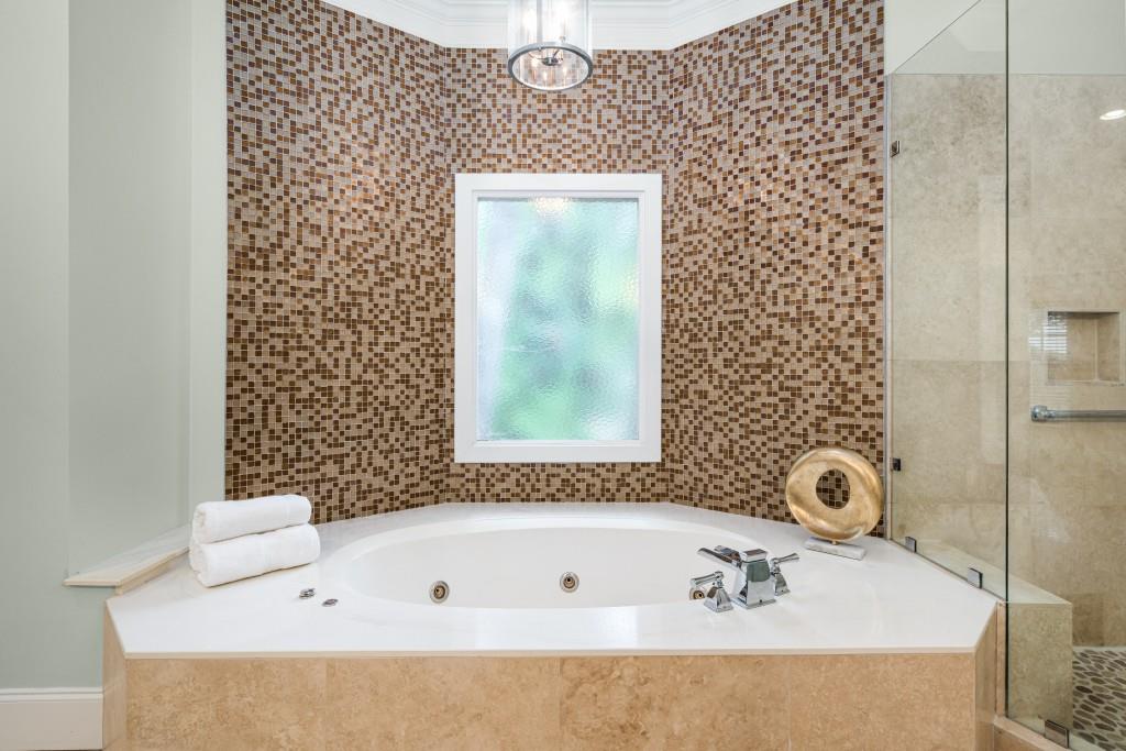 8345 Jett Ferry Road Sandy Springs, GA 30350 - Photo 18 of 61 a bathroom with a bathtub and a shower