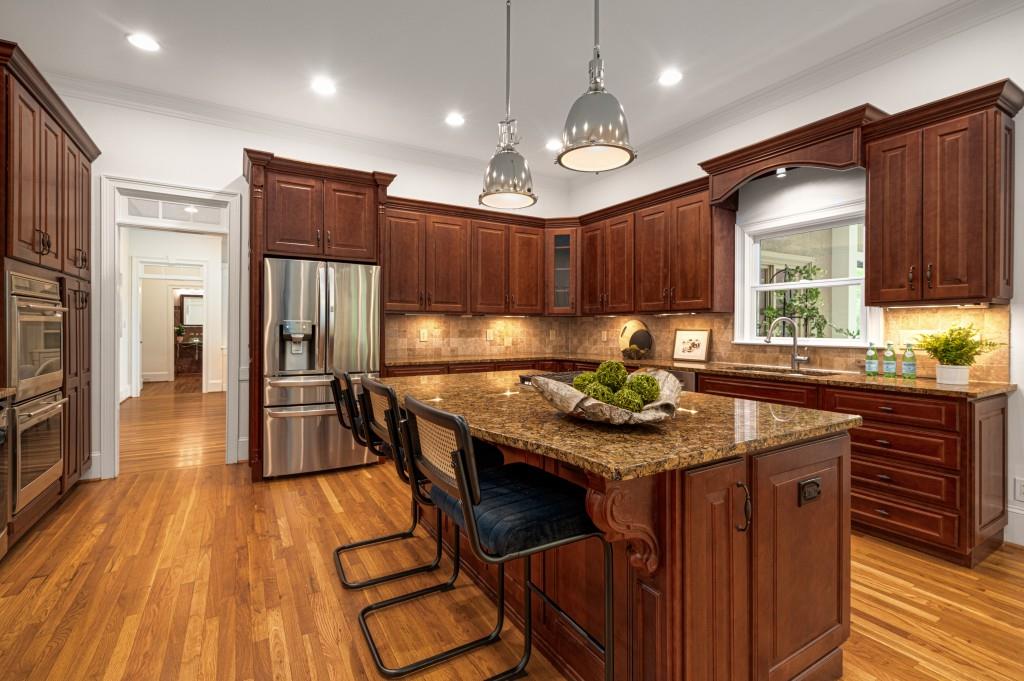 8345 Jett Ferry Road Sandy Springs, GA 30350 - Photo 20 of 61 a kitchen with stainless steel appliances granite countertop a stove a refrigerator and a wooden cabinets