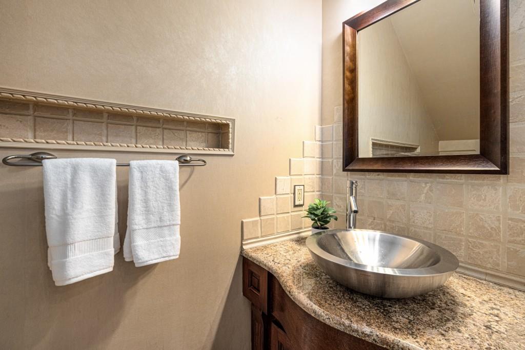 8345 Jett Ferry Road Sandy Springs, GA 30350 - Photo 28 of 61 a bathroom with a granite countertop sink a mirror and shower