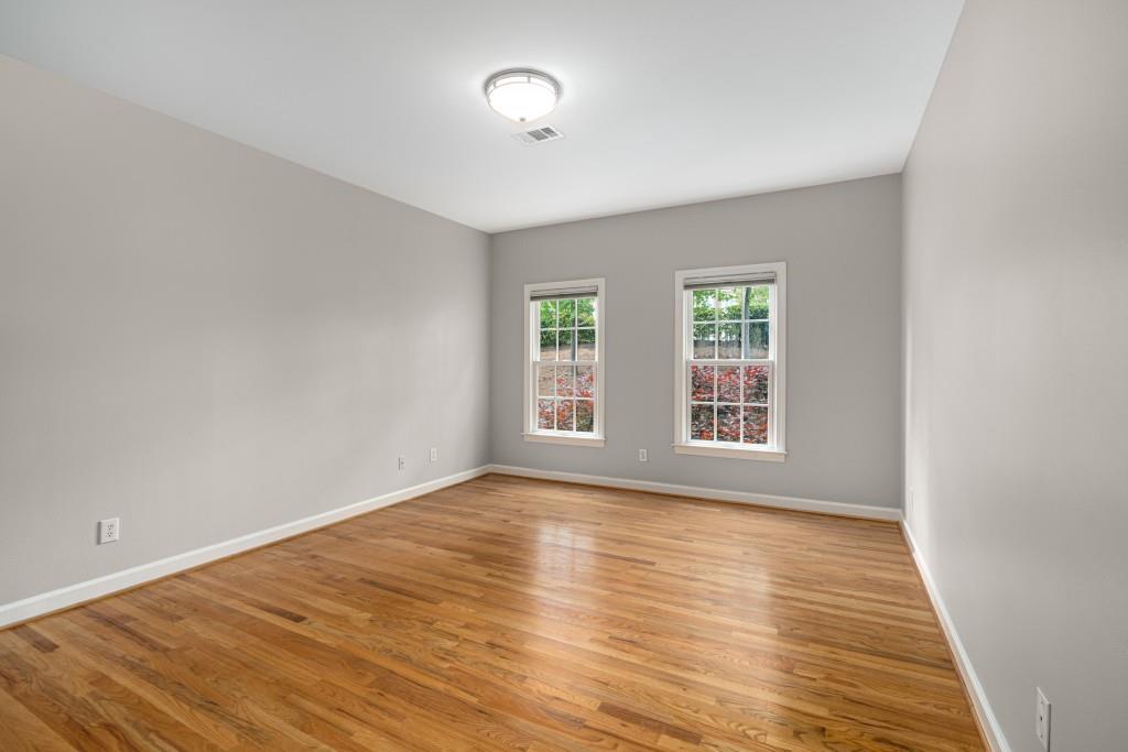 8345 Jett Ferry Road Sandy Springs, GA 30350 - Photo 34 of 61 a view of an empty room with wooden floor and a window
