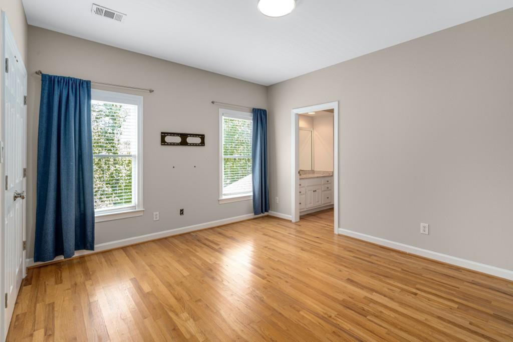 8345 Jett Ferry Road Sandy Springs, GA 30350 - Photo 36 of 61 an empty room with wooden floor and windows