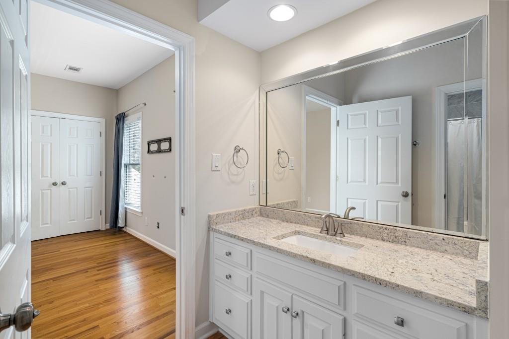 8345 Jett Ferry Road Sandy Springs, GA 30350 - Photo 37 of 61 a bathroom with a granite countertop sink and a mirror