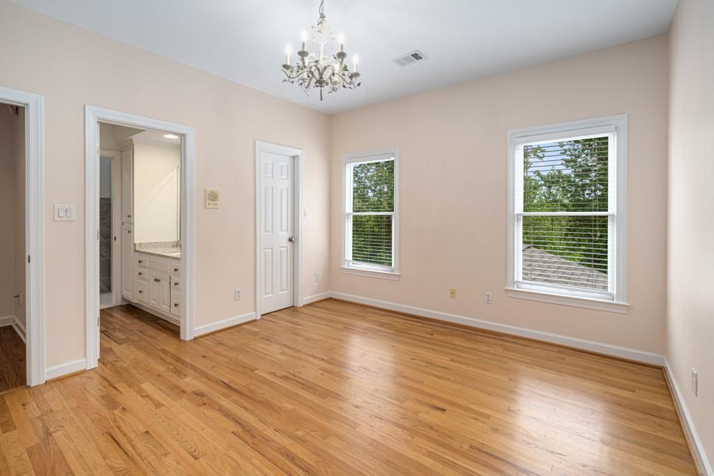 8345 Jett Ferry Road Sandy Springs, GA 30350 - Photo 39 of 61 a view of an empty room with wooden floor and a window