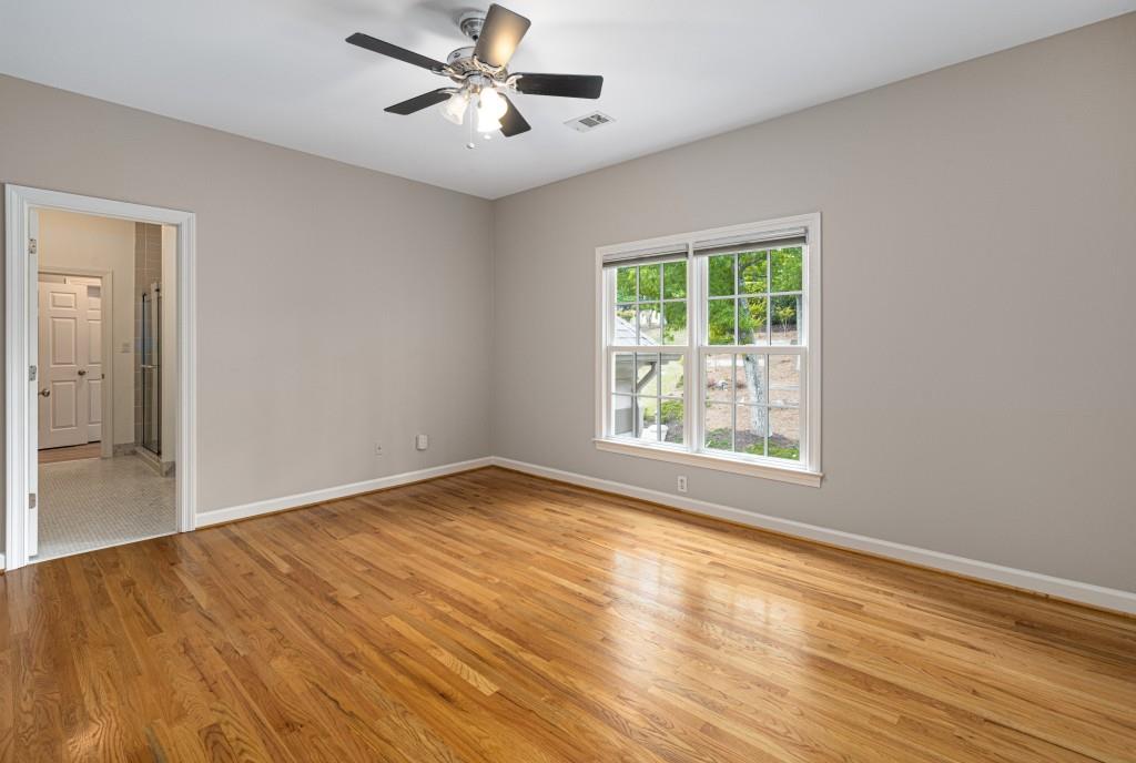 8345 Jett Ferry Road Sandy Springs, GA 30350 - Photo 40 of 61 a view of empty room with wooden floor and fan