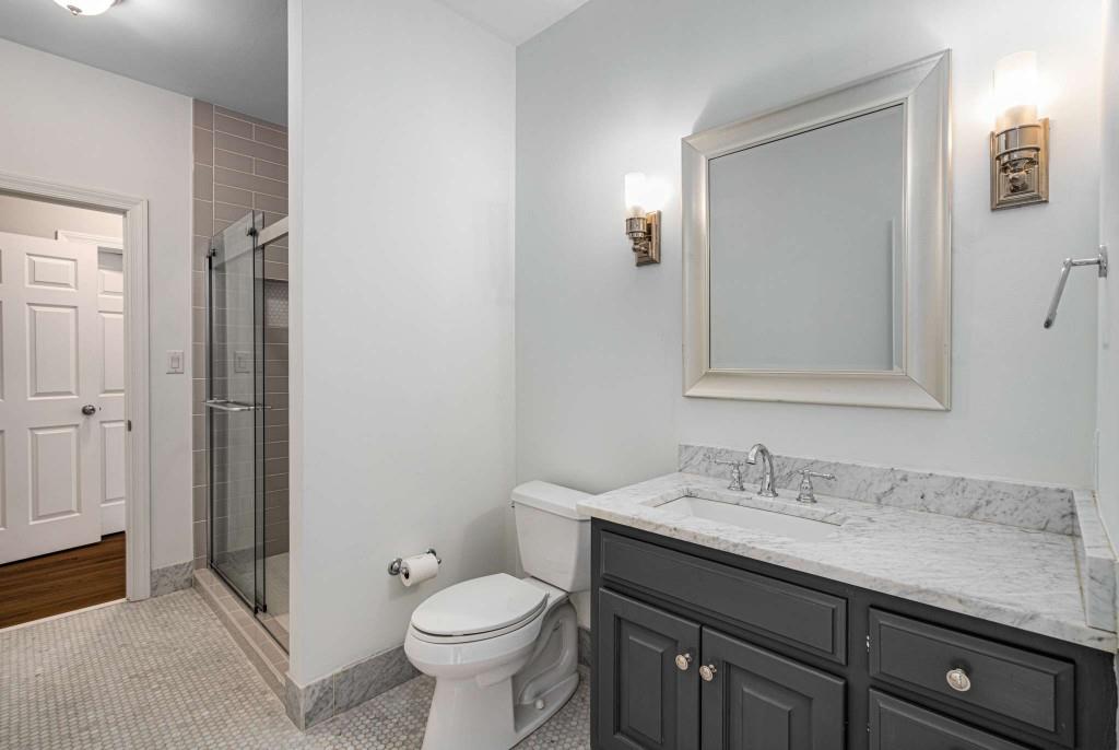 8345 Jett Ferry Road Sandy Springs, GA 30350 - Photo 41 of 61 a bathroom with a granite countertop toilet sink and mirror