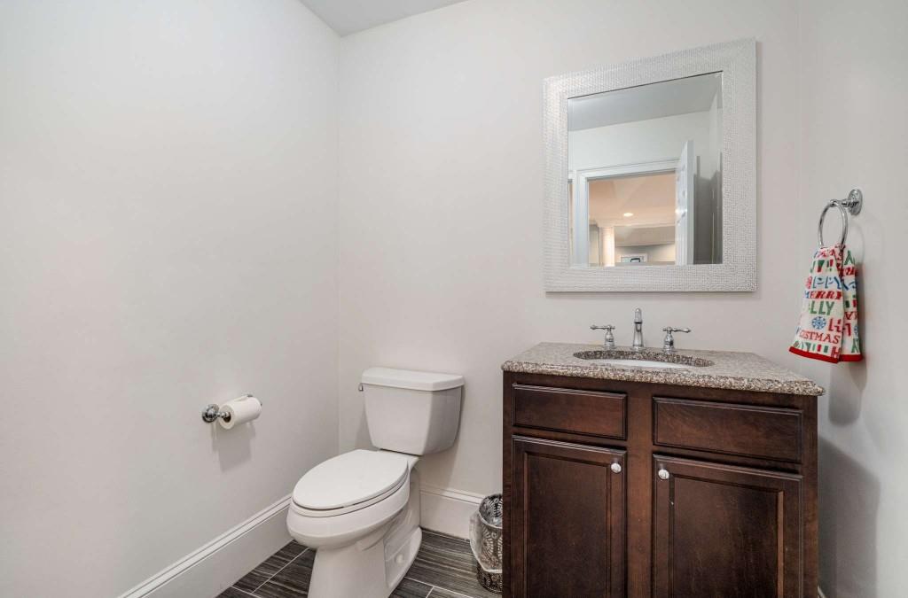 8345 Jett Ferry Road Sandy Springs, GA 30350 - Photo 48 of 61 a bathroom with a toilet a sink and mirror