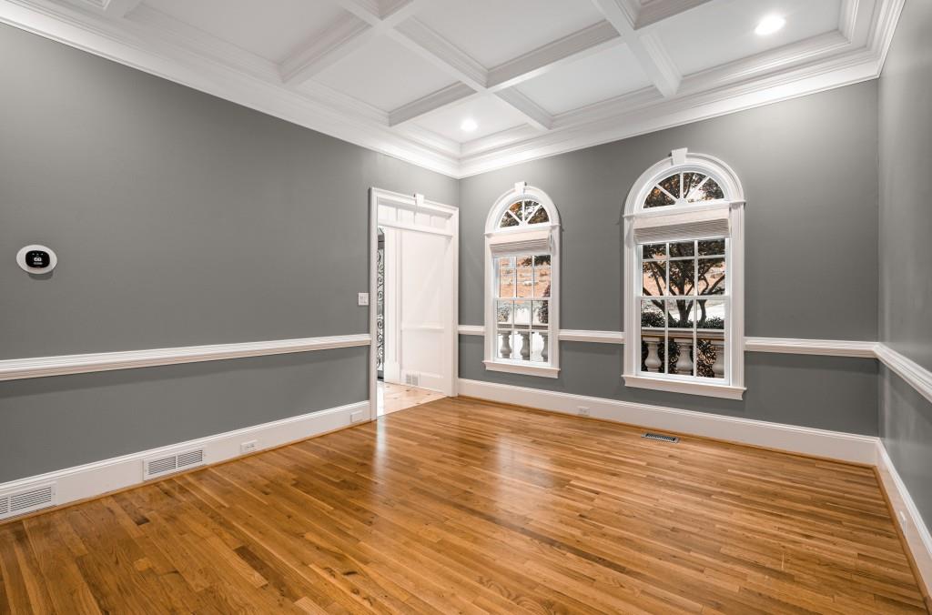 8345 Jett Ferry Road Sandy Springs, GA 30350 - Photo 8 of 61 a view of an empty room with wooden floor and window