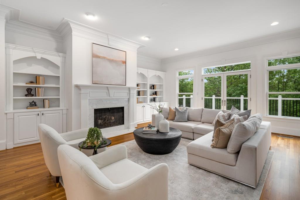 8345 Jett Ferry Road Sandy Springs, GA 30350 - Photo 10 of 61 a living room with furniture potted plant and a fireplace