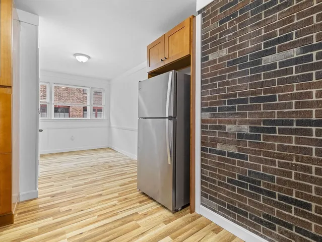 a view of a refrigerator in kitchen and wooden floor