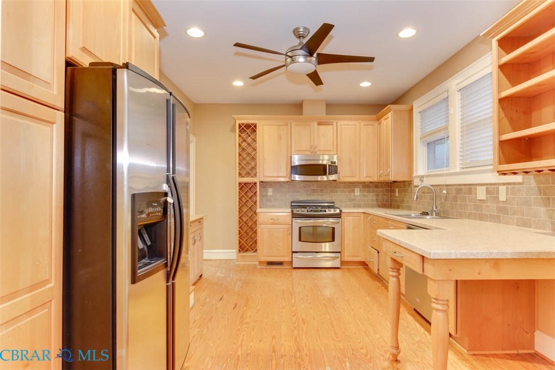 144 Meredith Street Hampton, VA 23669 - Photo 17 of 36 a kitchen with stainless steel appliances a refrigerator sink and cabinets