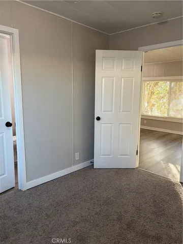 a view of an empty room and a window