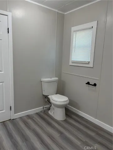 a white toilet sitting next to a bathroom sink