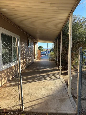 a view of a porch with a table and chairs