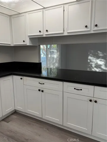 a kitchen with white cabinets and a sink