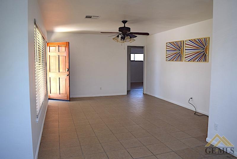 Undisclosed Address Bakersfield, CA 93305 - Photo 2 of 20 wooden floor in an empty room with a window