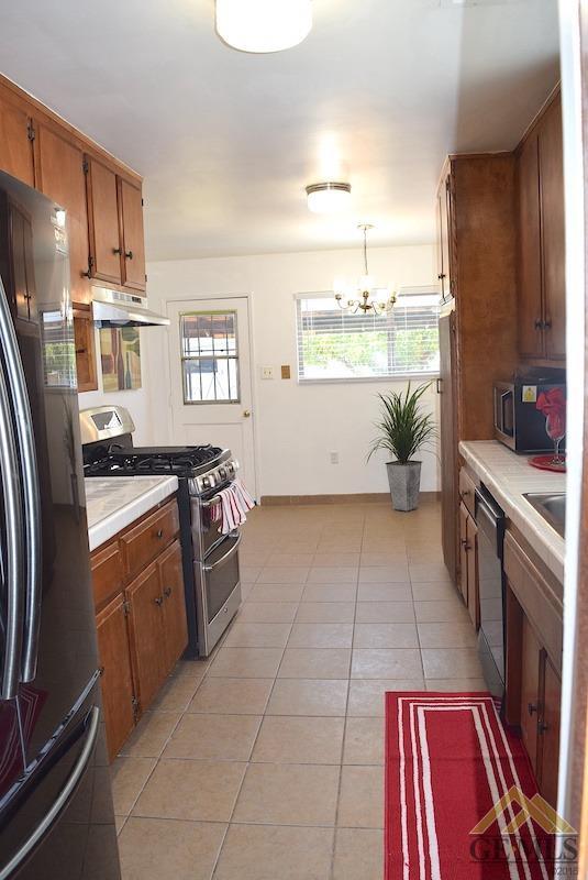Undisclosed Address Bakersfield, CA 93305 - Photo 5 of 20 a kitchen with a sink appliances and cabinets