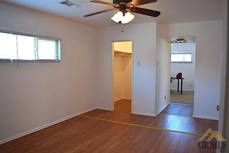 Undisclosed Address Bakersfield, CA 93305 - Photo 6 of 20 wooden floor in an empty room with a window