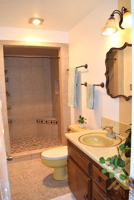 Undisclosed Address Bakersfield, CA 93305 - Photo 8 of 20 a bathroom with a granite countertop sink toilet and shower