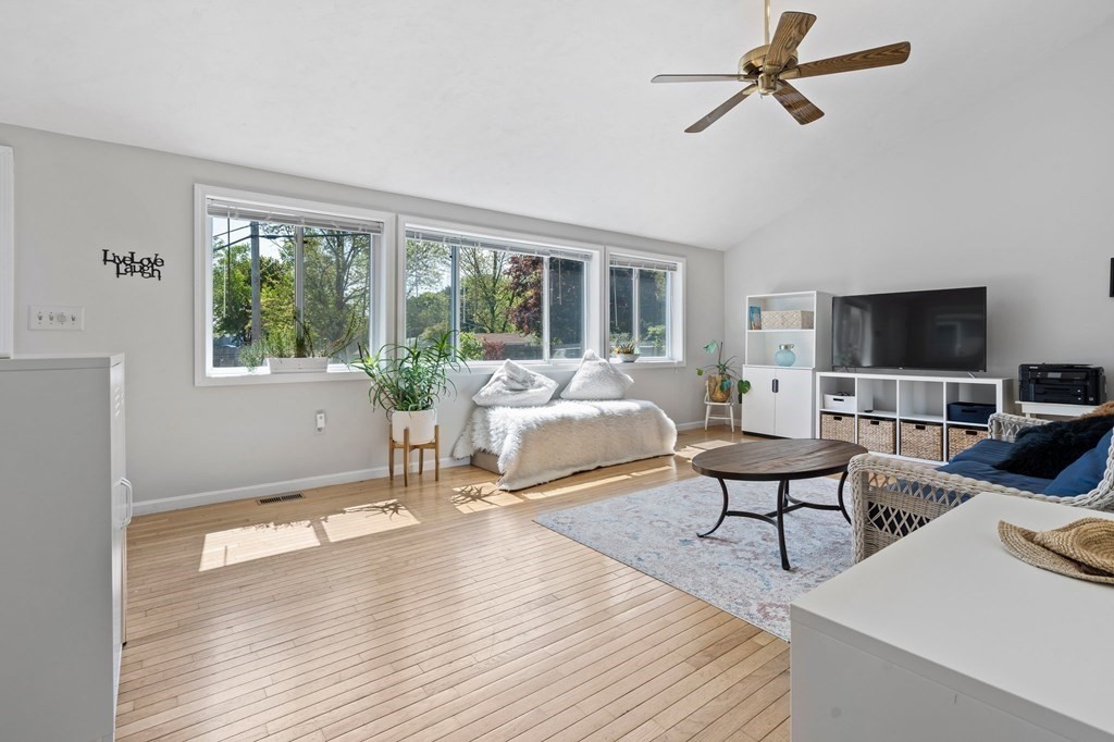 3 Bates Grove Road Webster, MA 01570 - Photo 18 of 40 a living room with furniture a fireplace and a flat screen tv