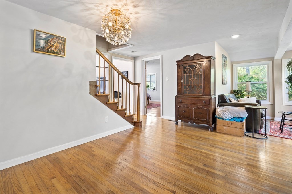 3 Bates Grove Road Webster, MA 01570 - Photo 20 of 40 a view of a livingroom with furniture stairs wooden floor and windows