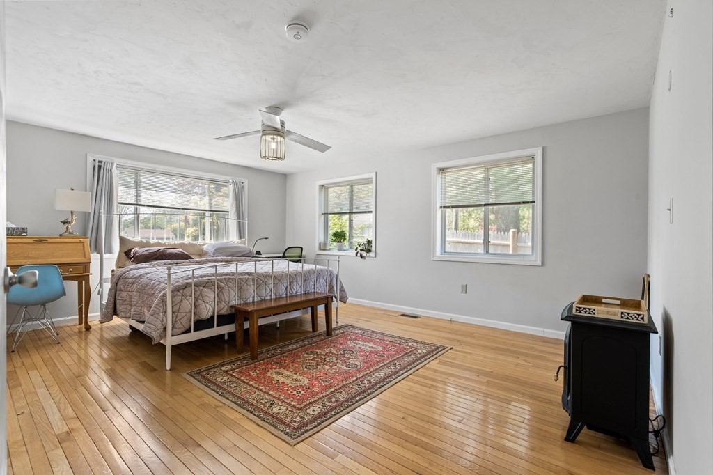 3 Bates Grove Road Webster, MA 01570 - Photo 24 of 40 a bedroom with a bed and wooden floor
