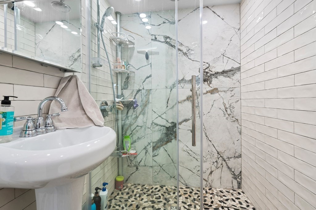 3 Bates Grove Road Webster, MA 01570 - Photo 30 of 40 a bathroom with a sink and shower