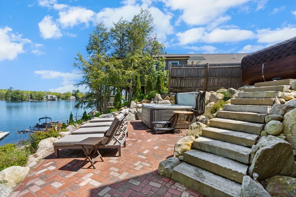 3 Bates Grove Road Webster, MA 01570 - Photo 10 of 40 a view of a patio with table and chairs with wooden floor and fence