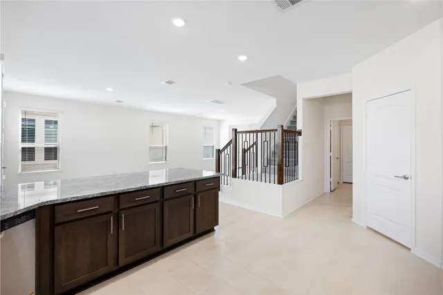 a large kitchen with stainless steel appliances granite countertop a stove a sink and a microwave