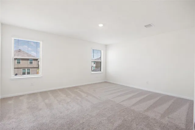 a spacious bathroom with a double vanity sink toilet and a mirror