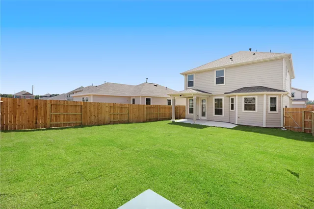 a view of a house with a yard and sitting area