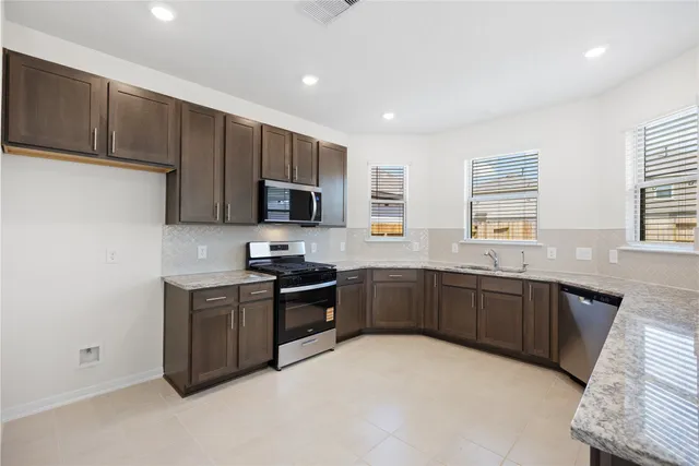 a view of a kitchen with a sink and a stove top oven