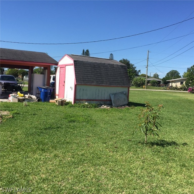 303 Davis Road Lehigh Acres, FL 33936 - Photo 15 of 17 a view of a house with backyard