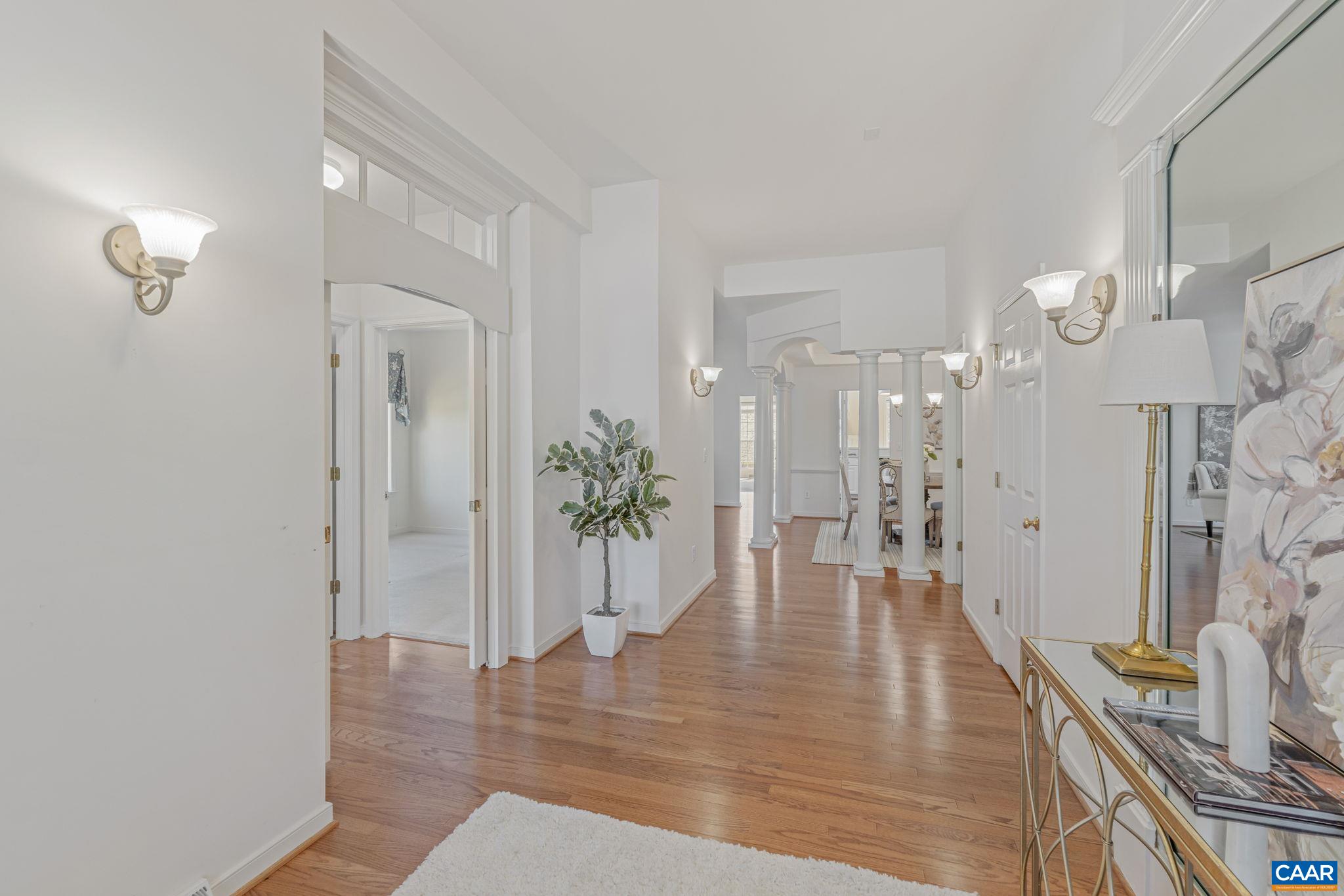 1347 Singleton Lane Charlottesville, VA 22903 - Photo 3 of 34 a view of a hallway with wooden floor and a chandelier