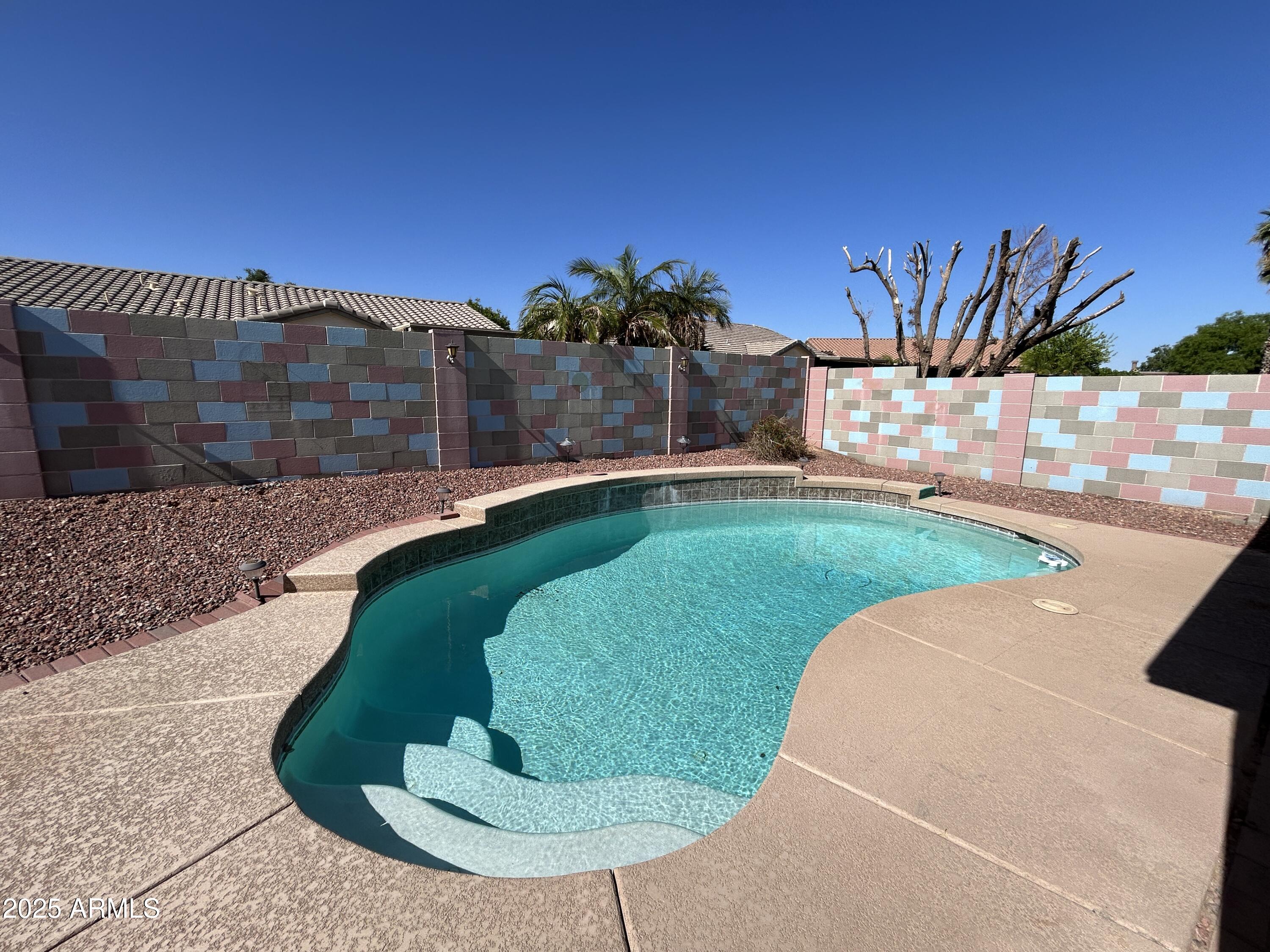 a view of a swimming pool with an outdoor seating