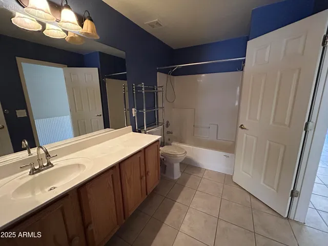 a bathroom with a sink a toilet a mirror and shower