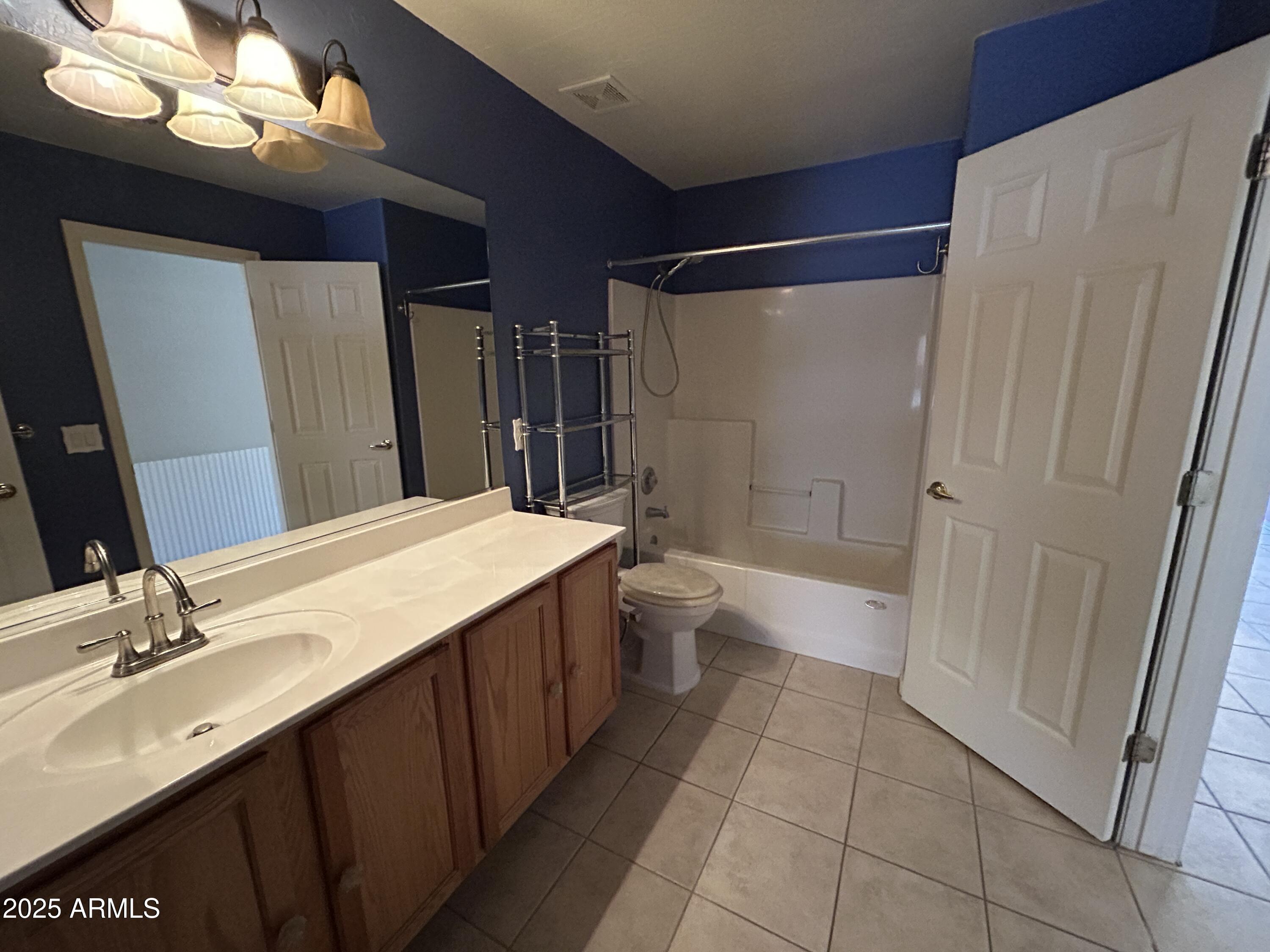 13444 West Paradise Lane Surprise, AZ 85374 - Photo 16 of 25 a bathroom with a sink a toilet a mirror and shower