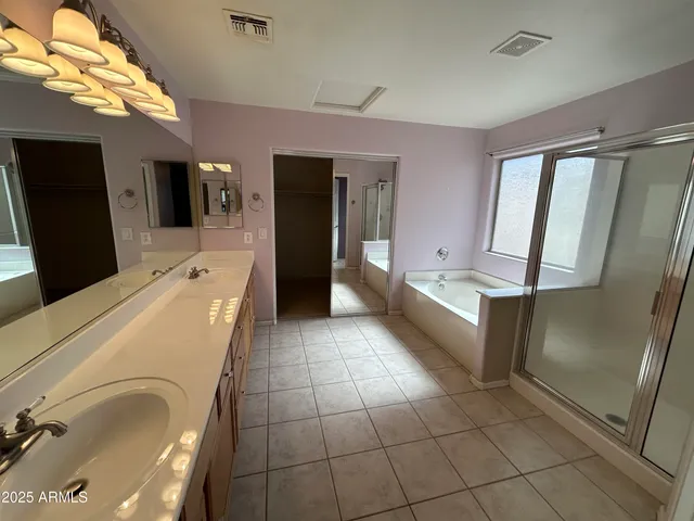 a kitchen with a sink a refrigerator and cabinets