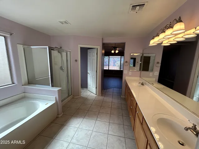 a bathroom with a tub sink and mirror