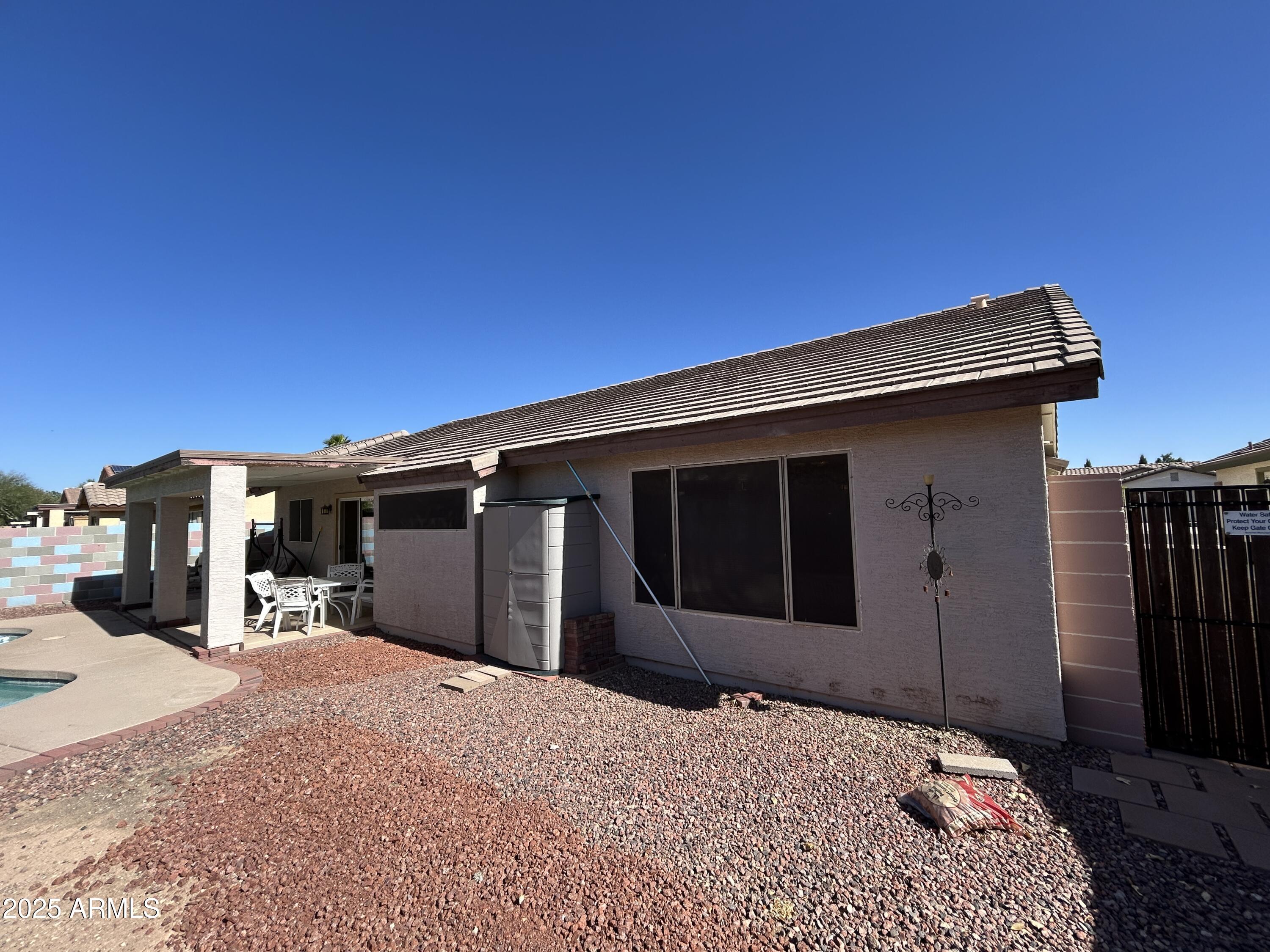 13444 West Paradise Lane Surprise, AZ 85374 - Photo 23 of 25 a wooden bench sitting in front of a building