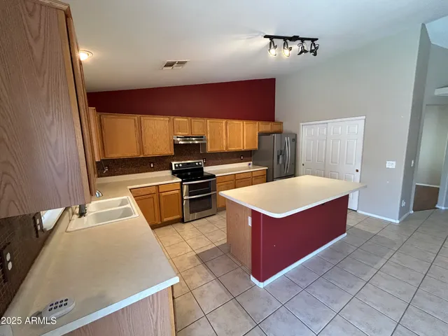 a kitchen with stainless steel appliances a stove a sink and a microwave