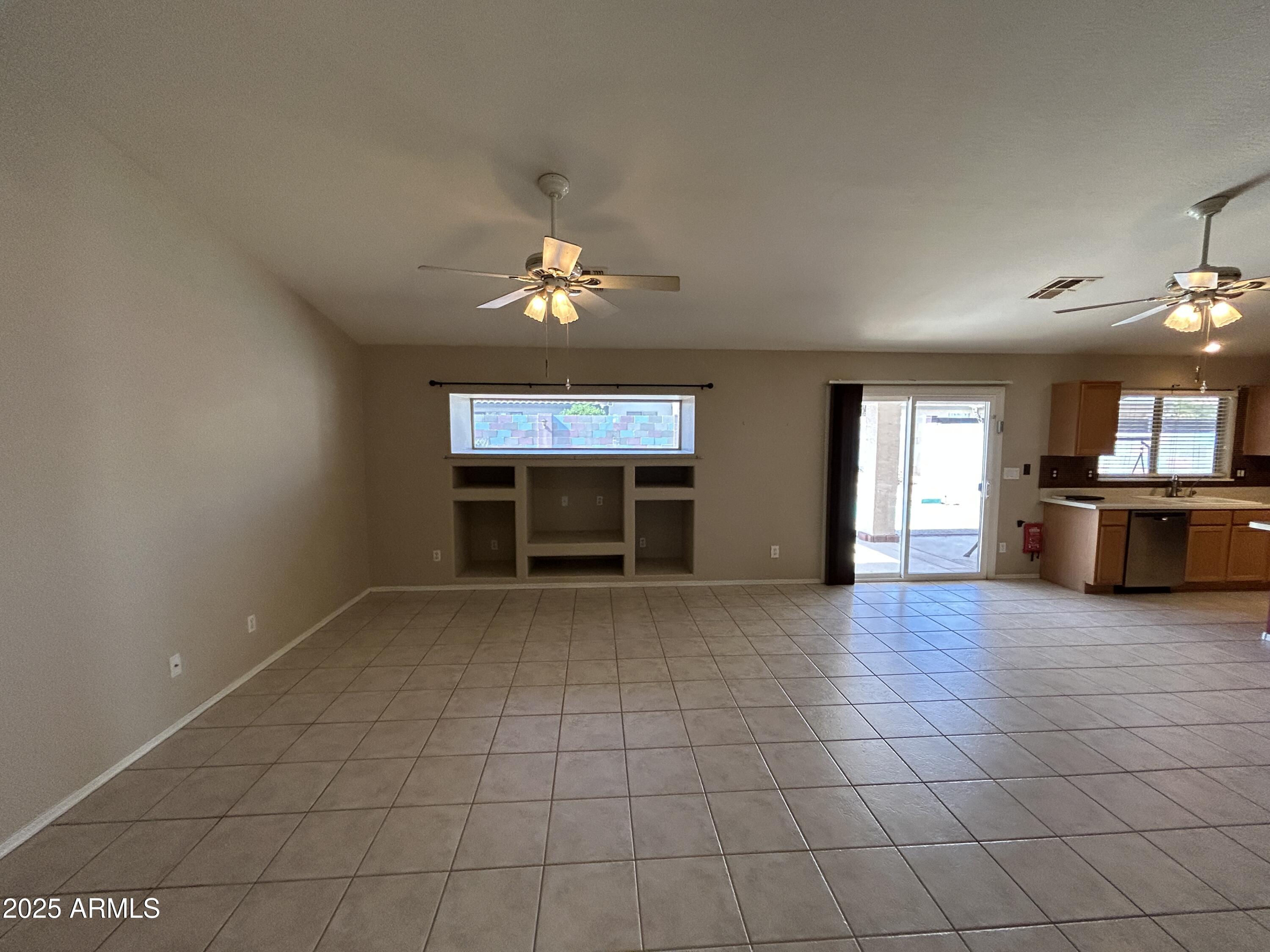 13444 West Paradise Lane Surprise, AZ 85374 - Photo 9 of 25 an empty room with windows and fireplace