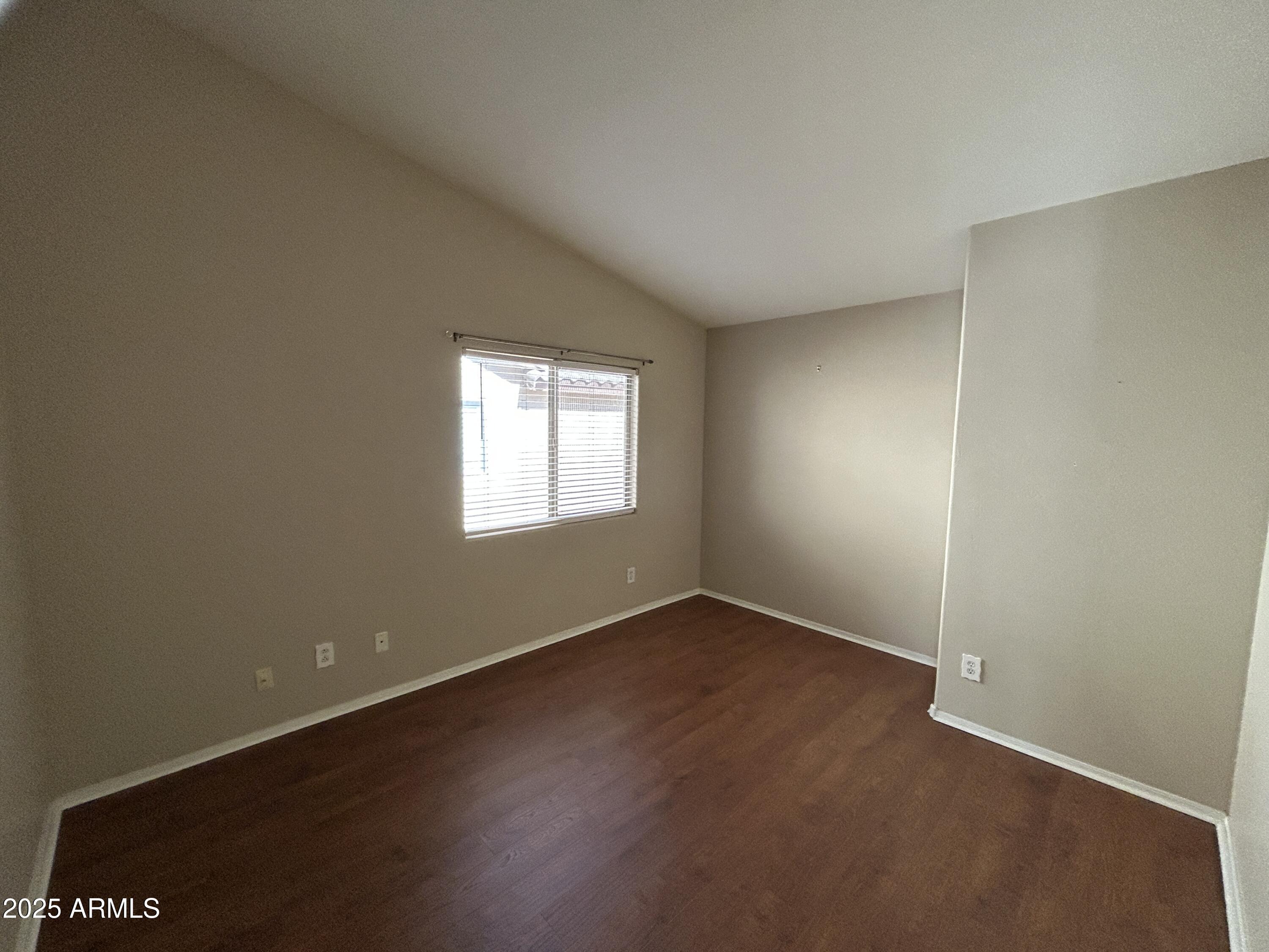 13444 West Paradise Lane Surprise, AZ 85374 - Photo 10 of 25 an empty room with wooden floor and windows