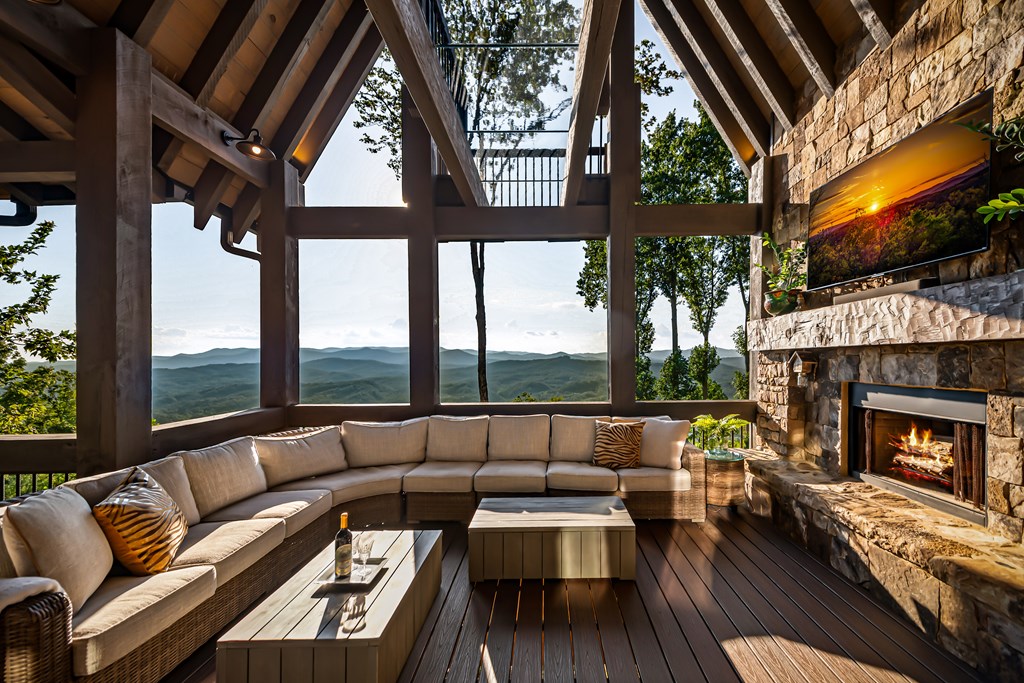 520 Overlook Drive Blue Ridge, GA 30513 - Photo 4 of 84 a living room with furniture a fireplace and floor to ceiling windows