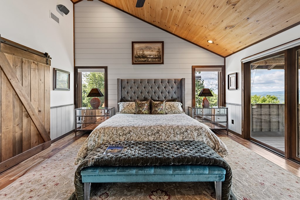 520 Overlook Drive Blue Ridge, GA 30513 - Photo 50 of 84 a bedroom with a large bed and a flat tv screen