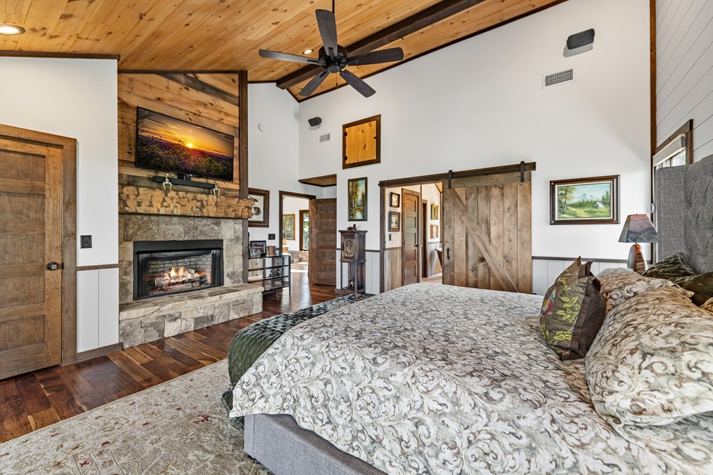 520 Overlook Drive Blue Ridge, GA 30513 - Photo 53 of 84 a bed sitting in a spacious bedroom next to a fireplace